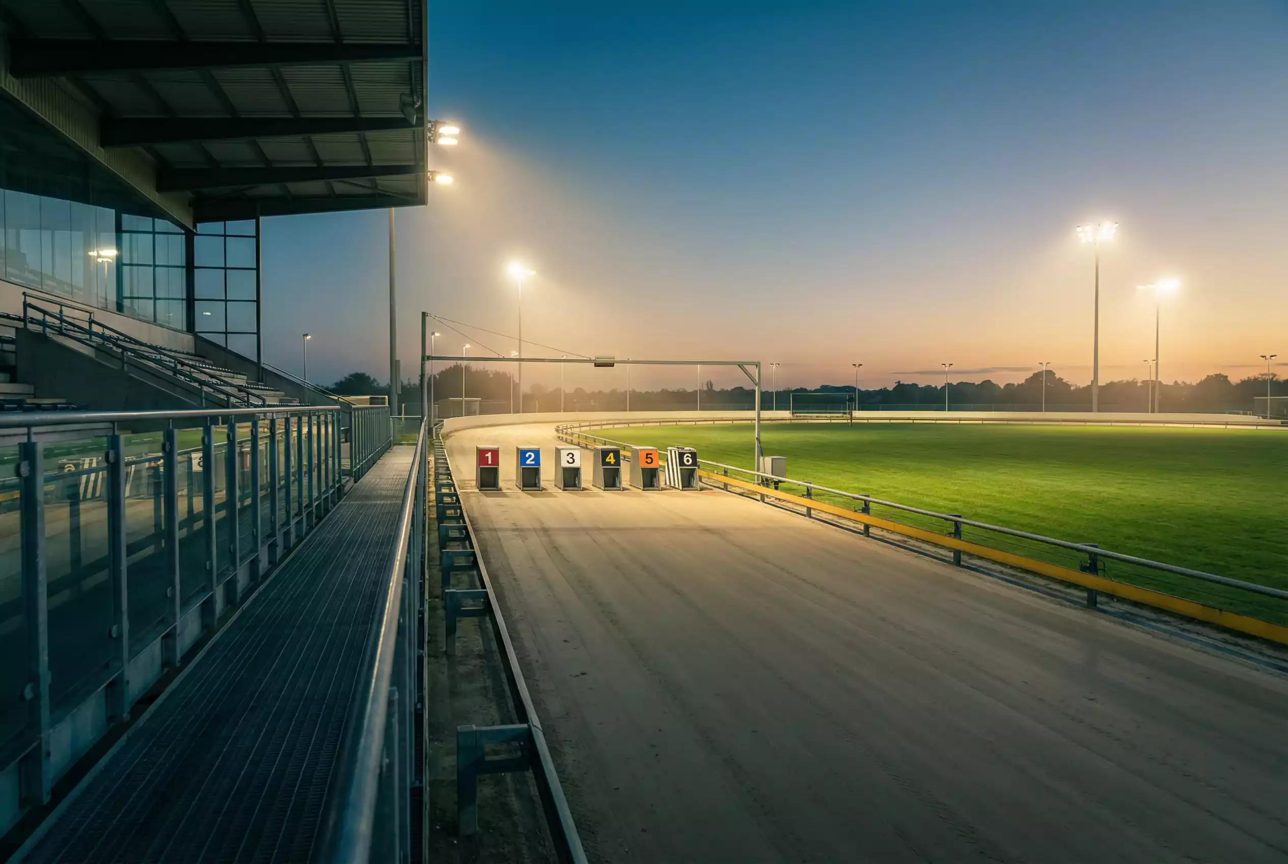 Central Park greyhound stadium under floodlights during an evening race meeting in Sittingbourne, Kent